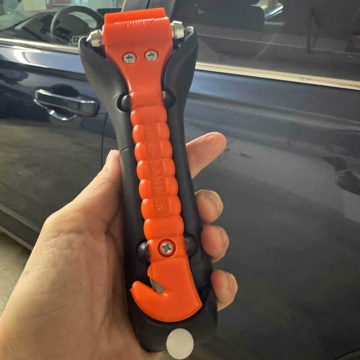 Image of a hand holding a tool to keep in your car.