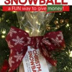 Snowball made out of white paper streamer with a tag that says, Christmas Snowball and a pretty bow tied around it.