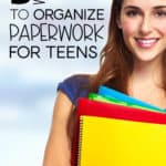 Teenage girl holding school folders.