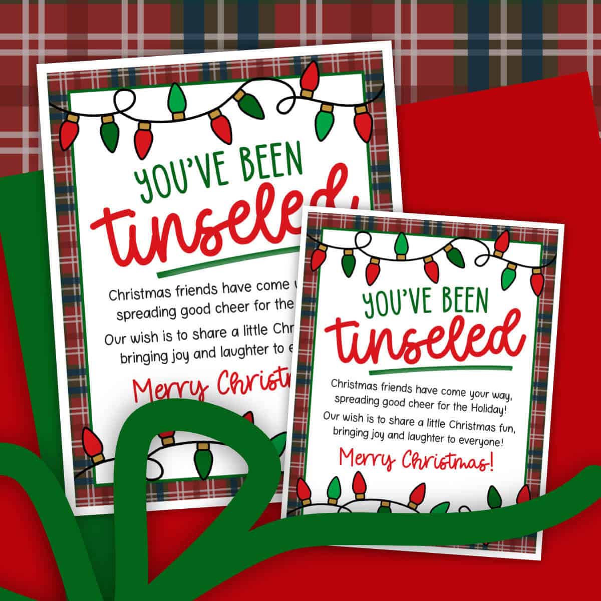 Image of two You've Been Tinseled tags in two different sizes and sitting on top of a clipart Christmas gift.