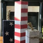 Firecrackers made out of a fence post and red, white, and blue paint with a rope top.