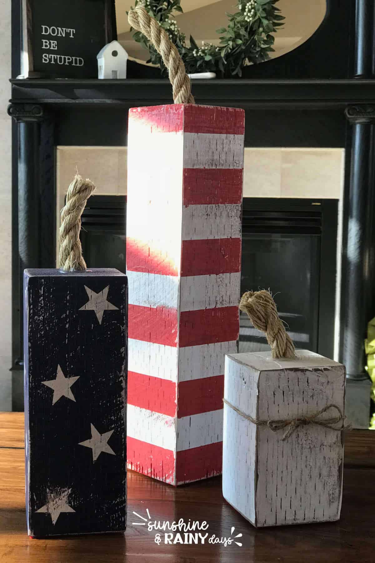 Firecrackers made out of a fence post and red, white, and blue paint with a rope top.