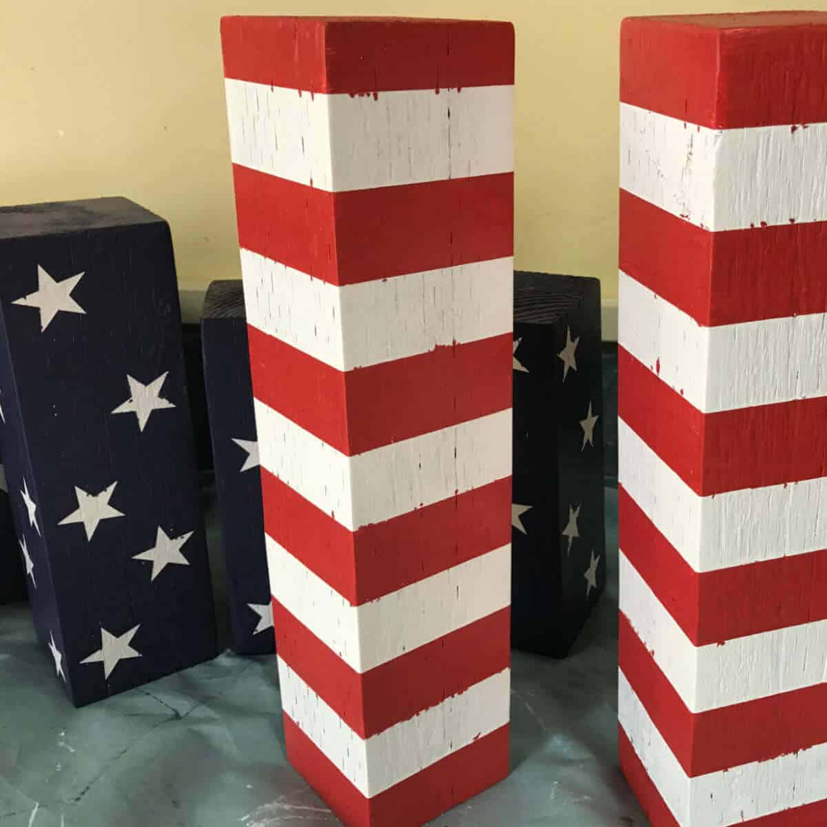 4 x 4 blocks that have been painted with red and white stripes and blue with white stars.