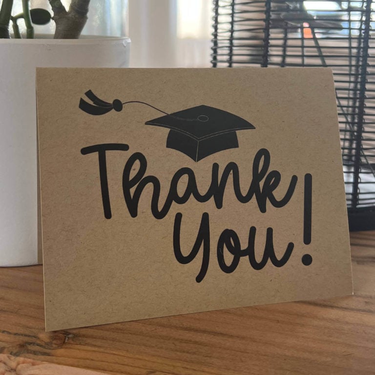 Image of a graduation thank you card sitting on a table.