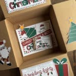 Image of a box that has the box flaps decorated with Christmas printables.