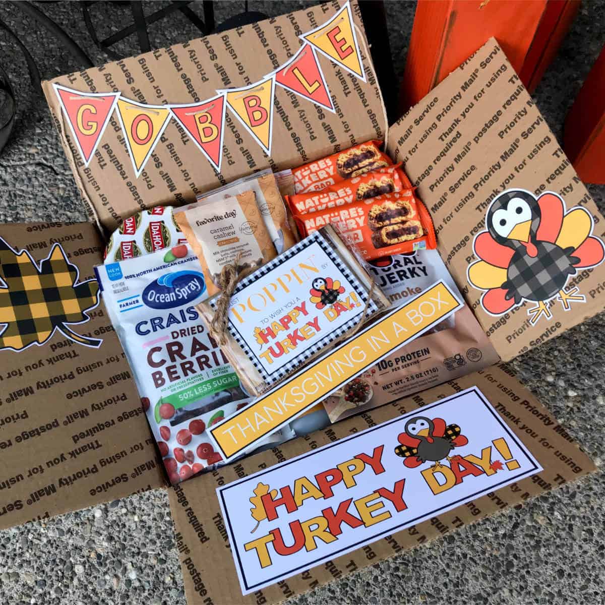 Thanksgiving care package with box decor and filled with Thanksgiving goodies.