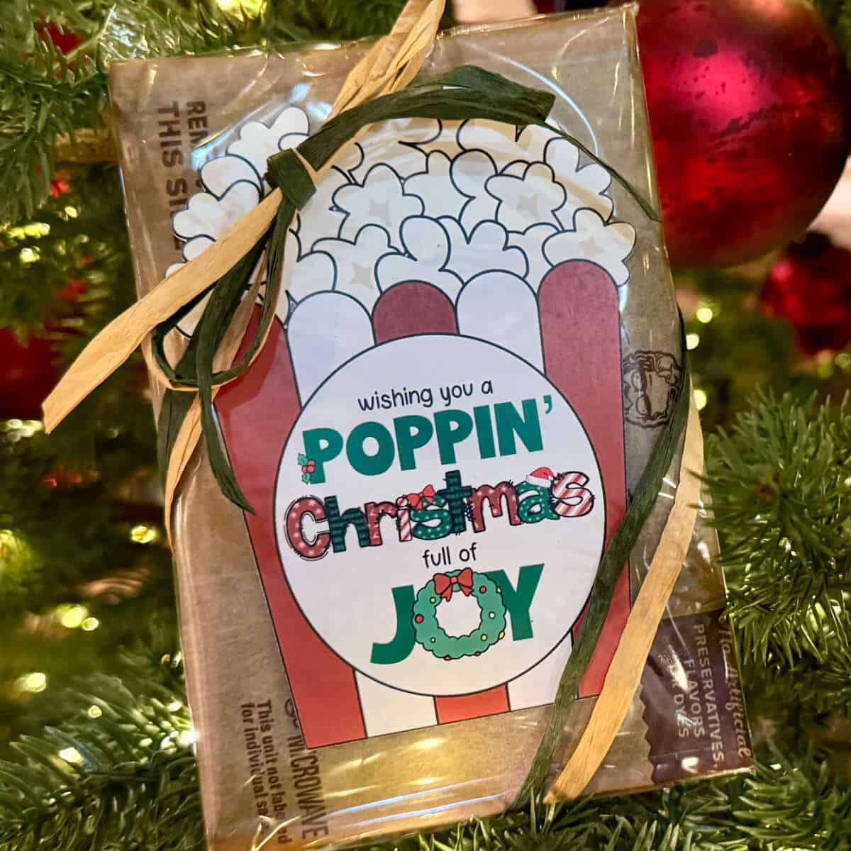 Tag on a bag of microwave popcorn that says Wishing You A Poppin' Christmas Full Of Joy.