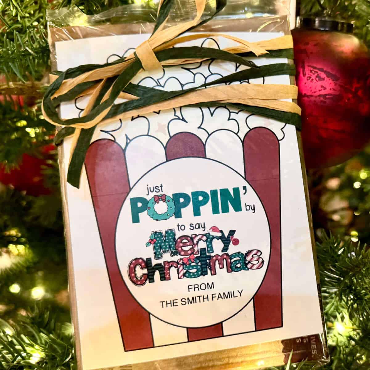 Tag on a bag of microwave popcorn that says Just Poppin' By To Say Merry Christmas.