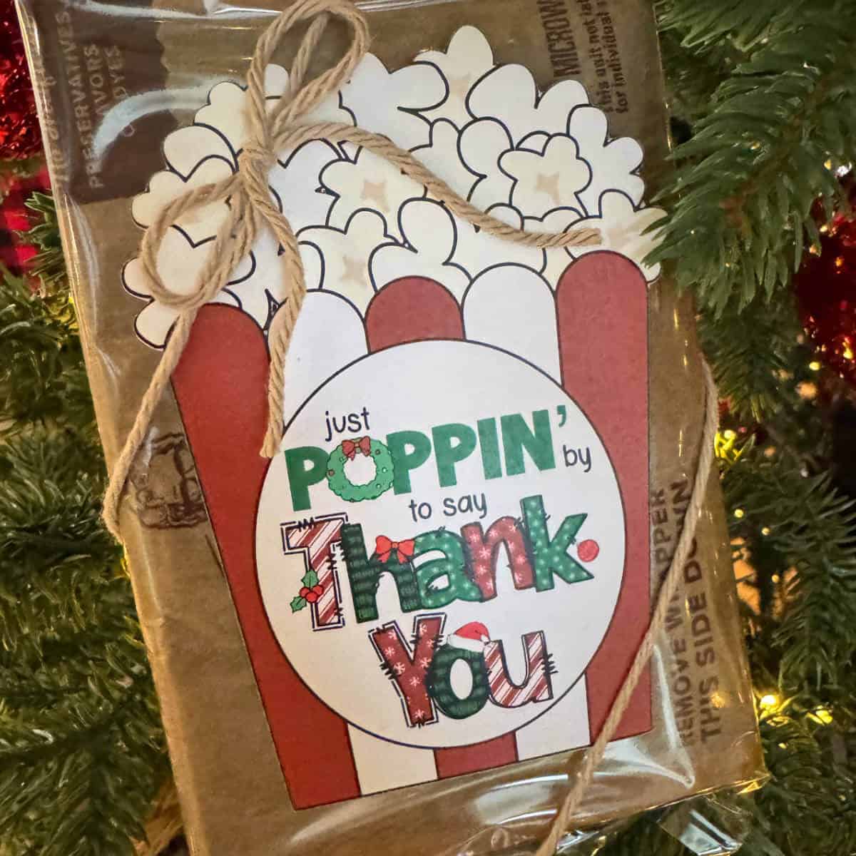 Tag on microwave popcorn that says Just Poppin' By To Say Thank You with a Christmas theme.