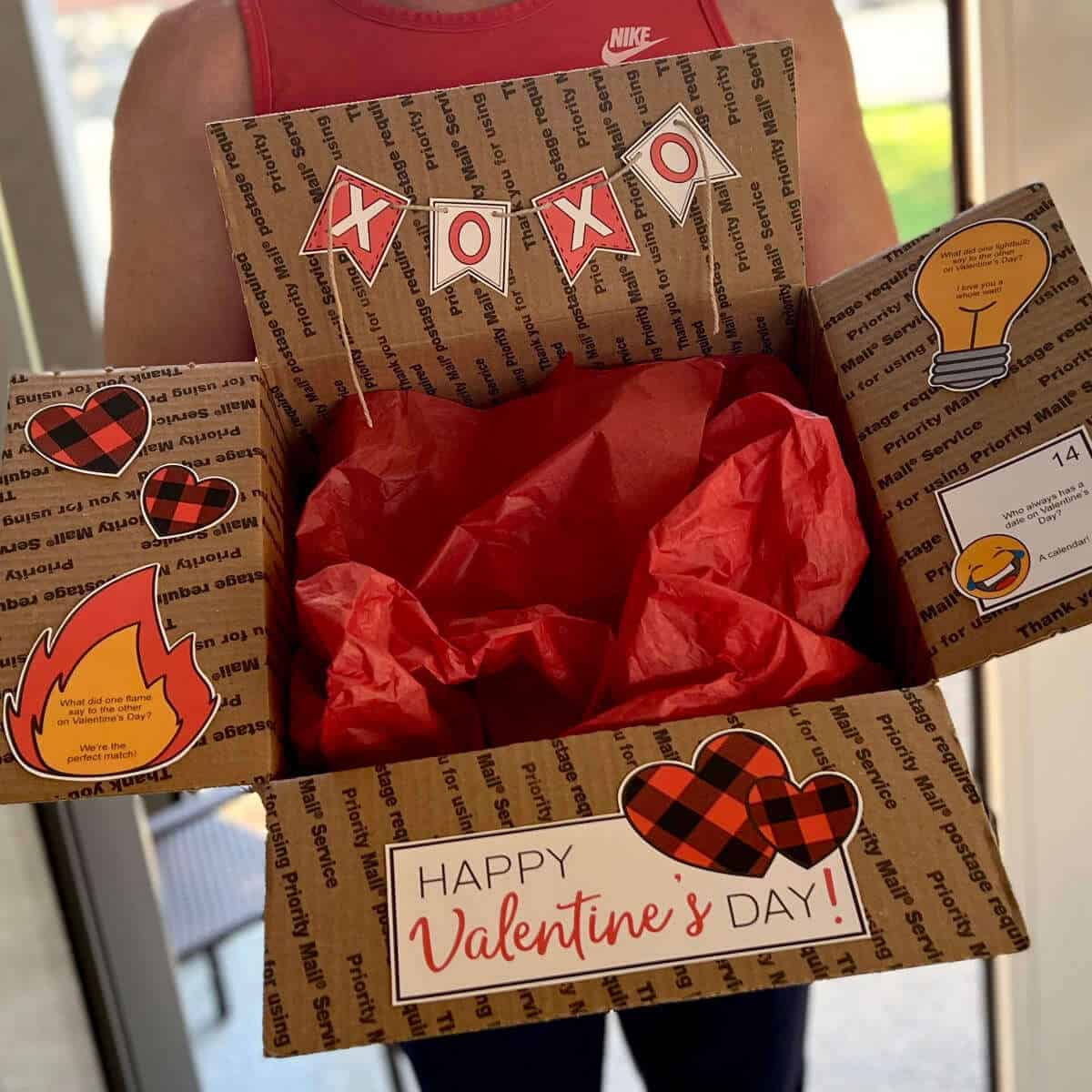 A man holding a box decorated for Valentine's Day.