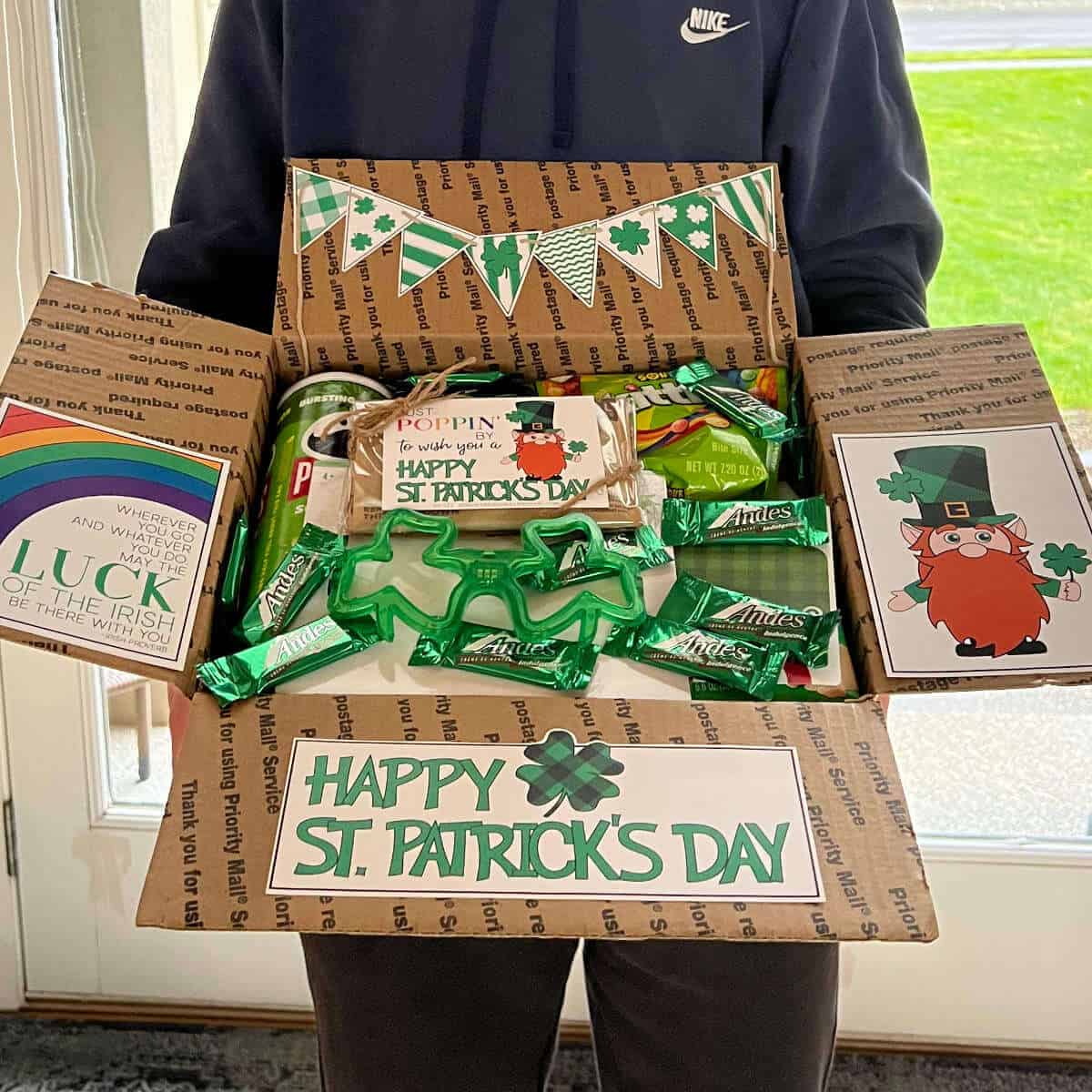 Someone holding an open box full of St. Patrick's Day fun.