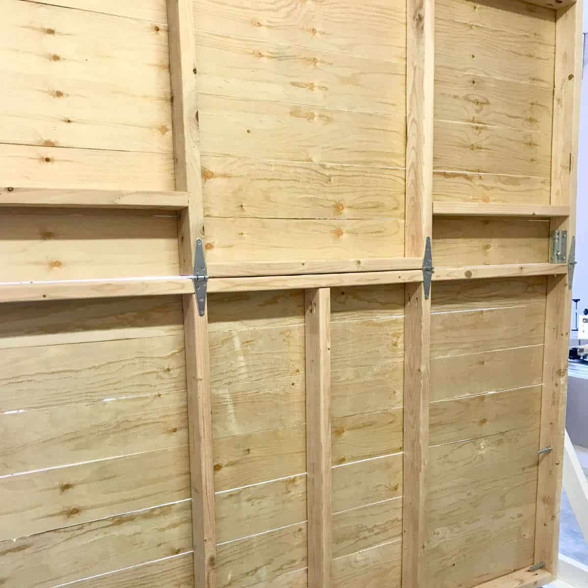 The back side of a backdrop wall made out of wood.