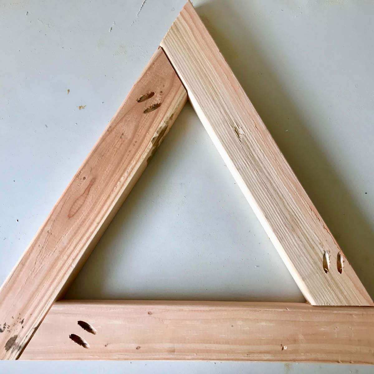 Triangle shaped wood leg for a photo backdrop wall.