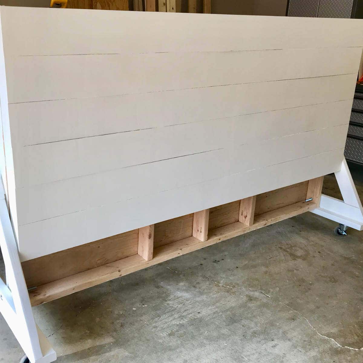 Folded backdrop wall on wheels that's been build out of wood.