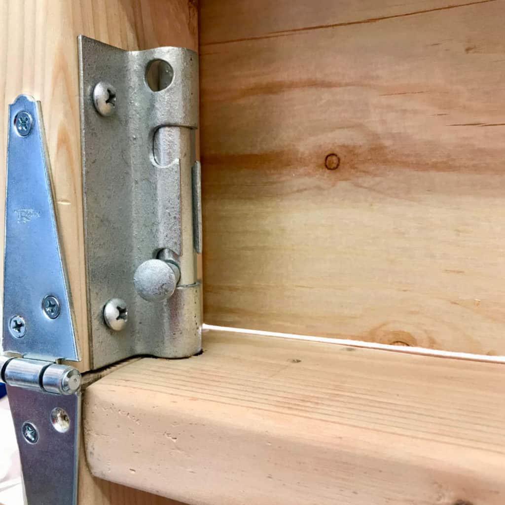 Barrel bolt attached to a frame and going through a 2 x 4.