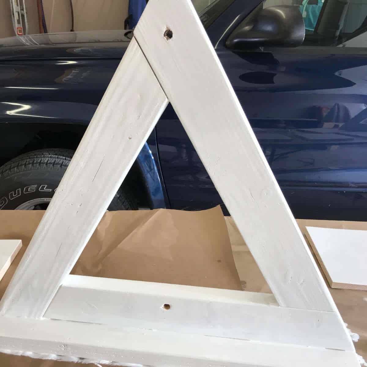 2 x 4 wood triangle leg for a backdrop wall painted white.