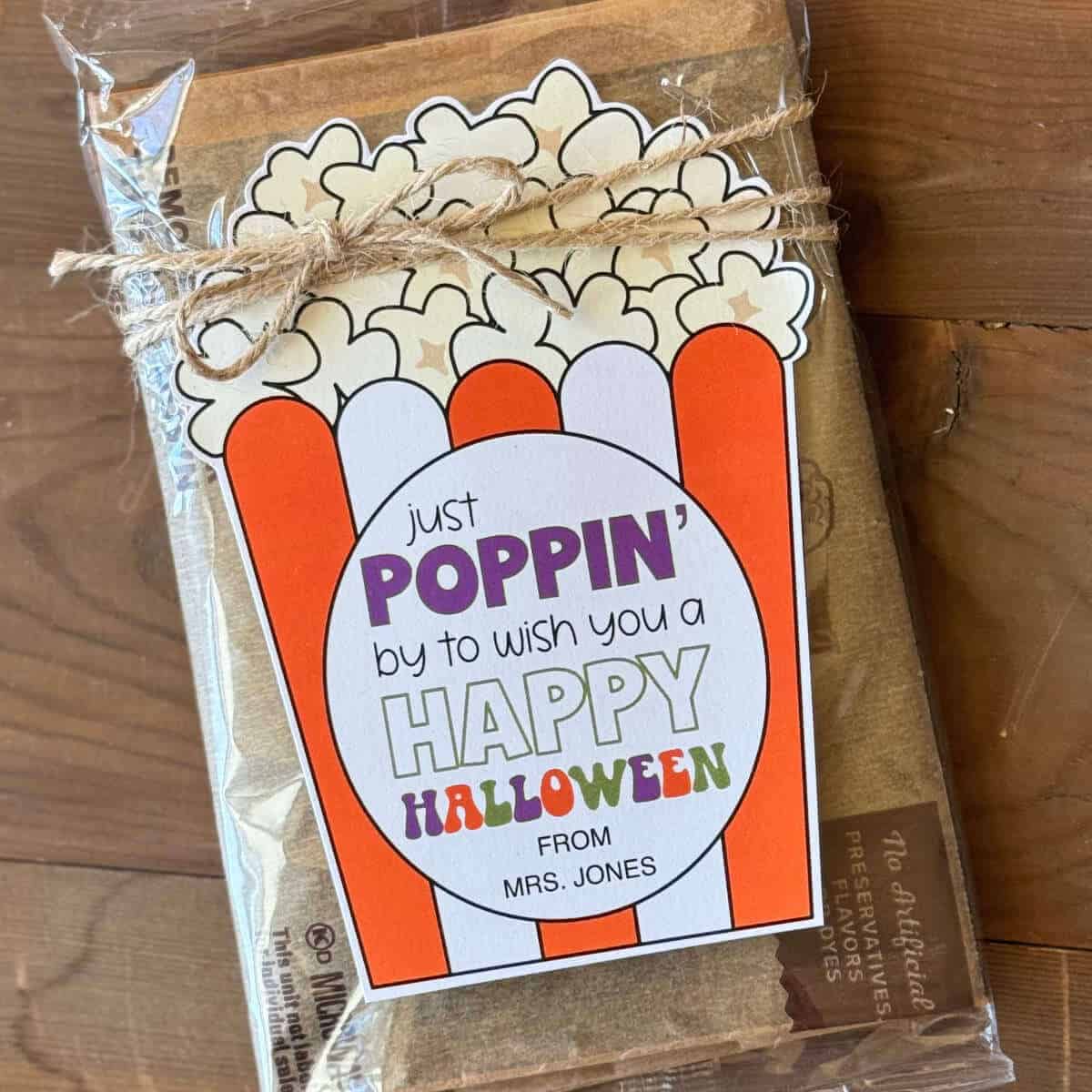 Just Poppin' By To Wish You A Happy Halloween printable tag on a bag of microwave popcorn.