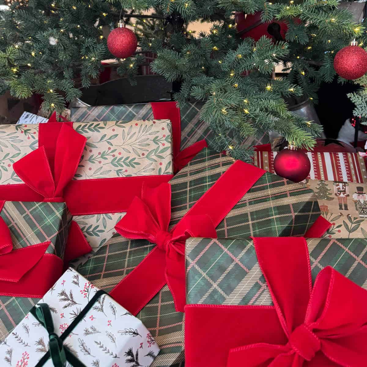 Christmas presents wrapped and under a Christmas tree.
