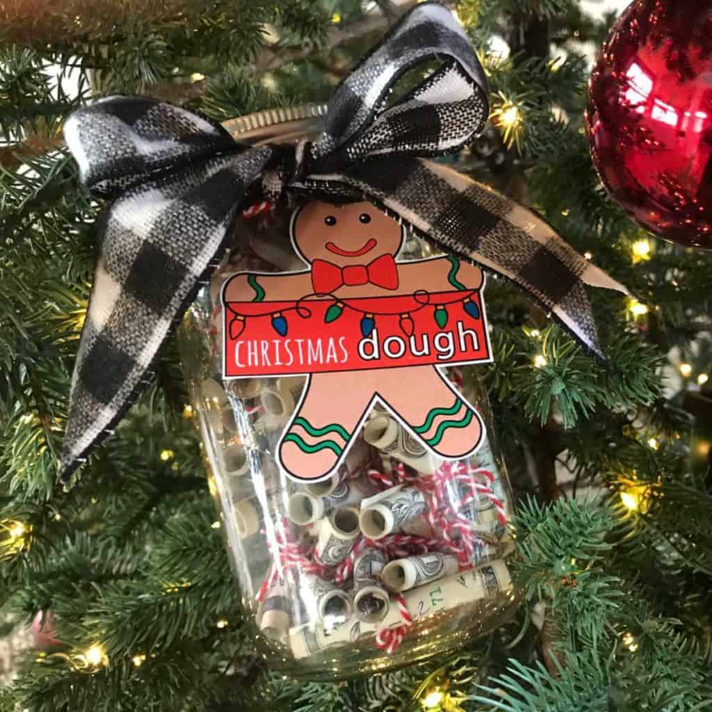 Money rolled up and tied, then placed in a jar with a tag that says Christmas Dough.