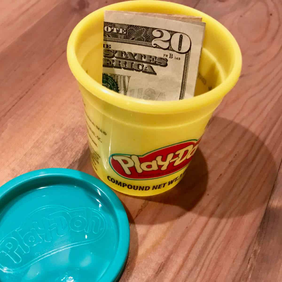 Money in a play-doh container to give as a gift with a play on the word dough.