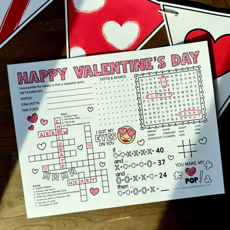 Printable Valentine activity sheet that is partially filled out and laying on top of a Valentine banner.