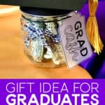 Image of a small jar with a paper graduation cap and a yellow tassel filled with rolled bills.