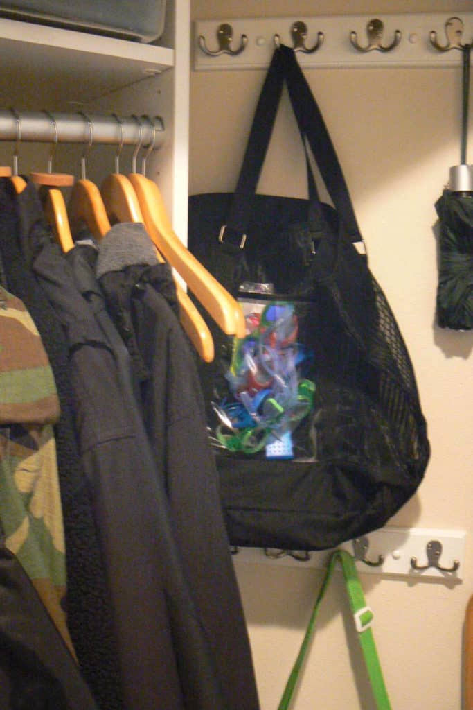 Swim bag and umbrella handing in the coat closet.