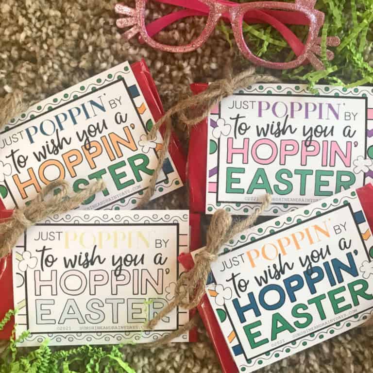 Four bags of microwave popcorn with Just Poppin' By To Wish You A Hoppin' Easter tags tied onto them with jute.