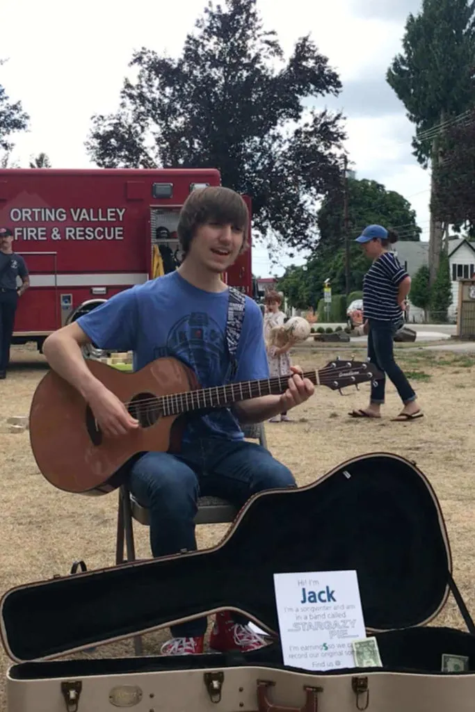 Teenager busking at a local farmer's market.