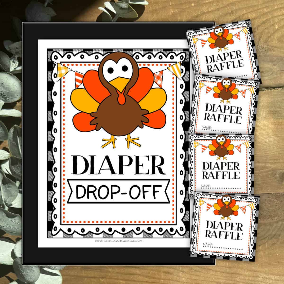 Framed sign that says Diaper Drop-Off with diaper raffle tickets next to it.