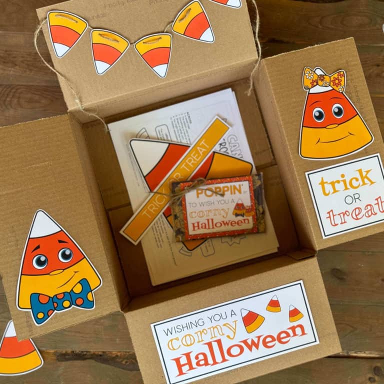 A care package box with printable candy corn decor on the box flaps for a Halloween care package.