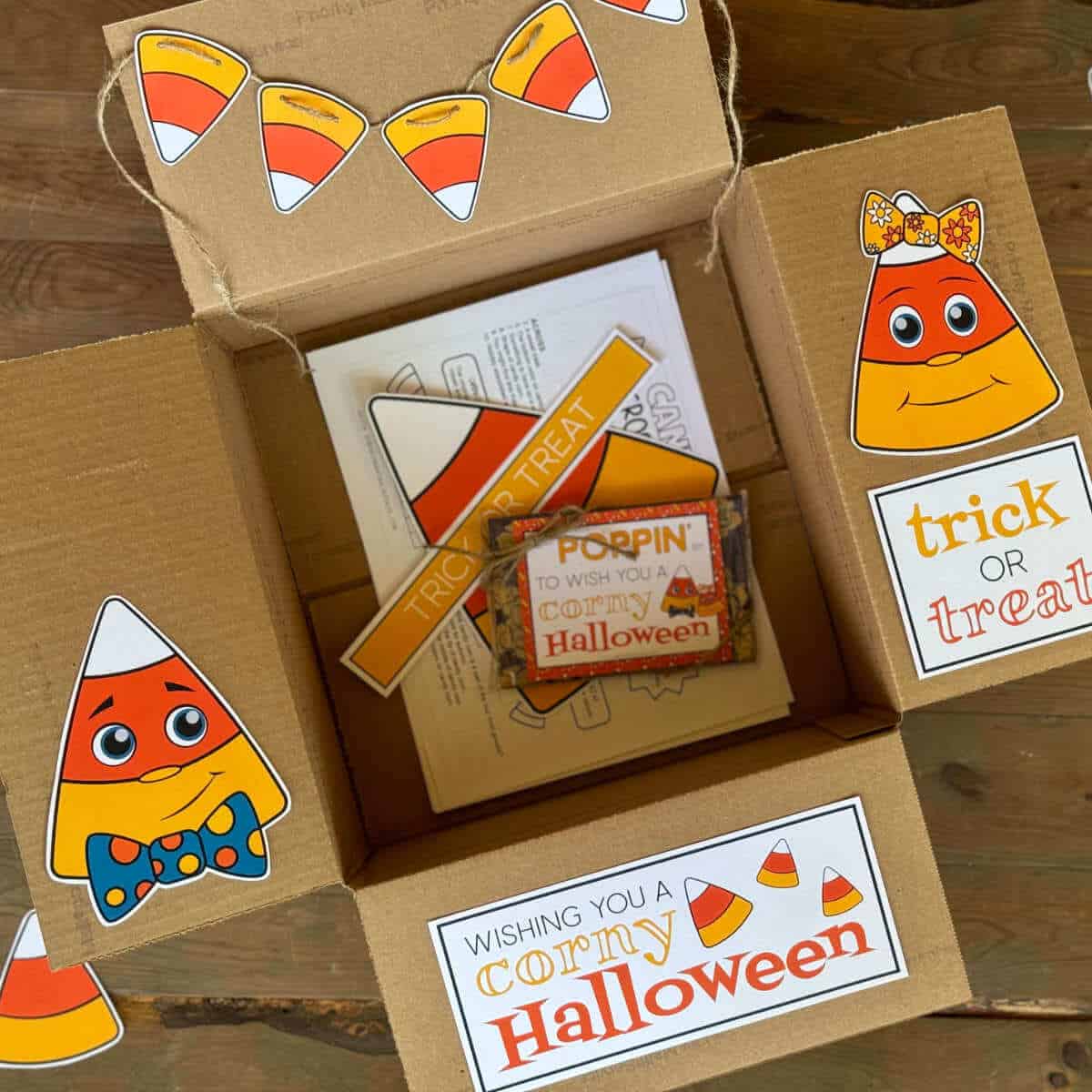 A care package box with printable candy corn decor on the box flaps for a Halloween care package.