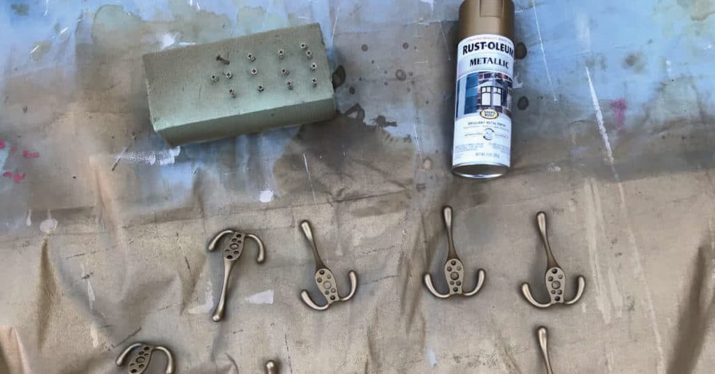 Spray painting coat hooks.