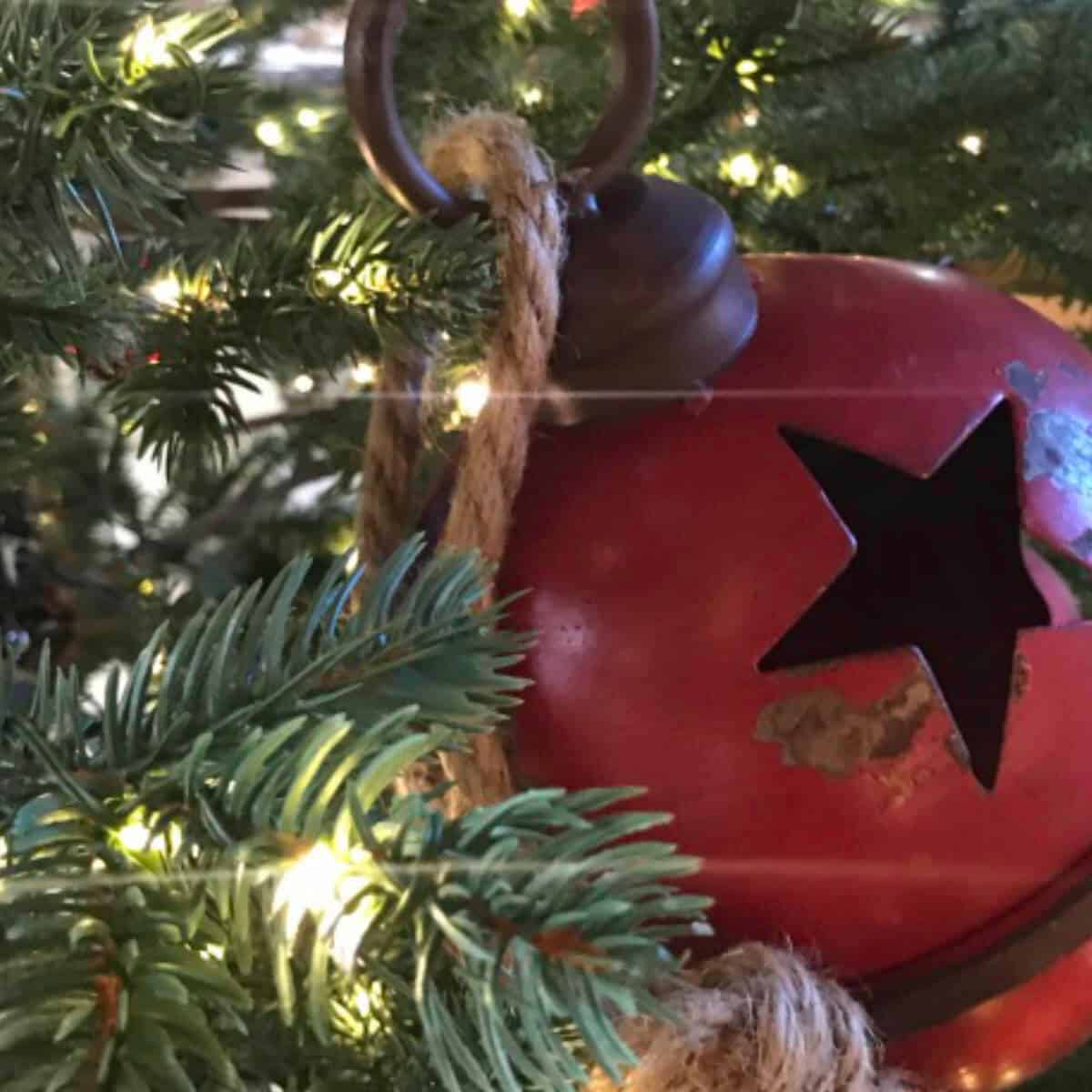 Picture of a large red bell in a Christmas tree.