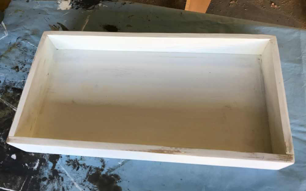 DIY wood tray that has been painted with primer.