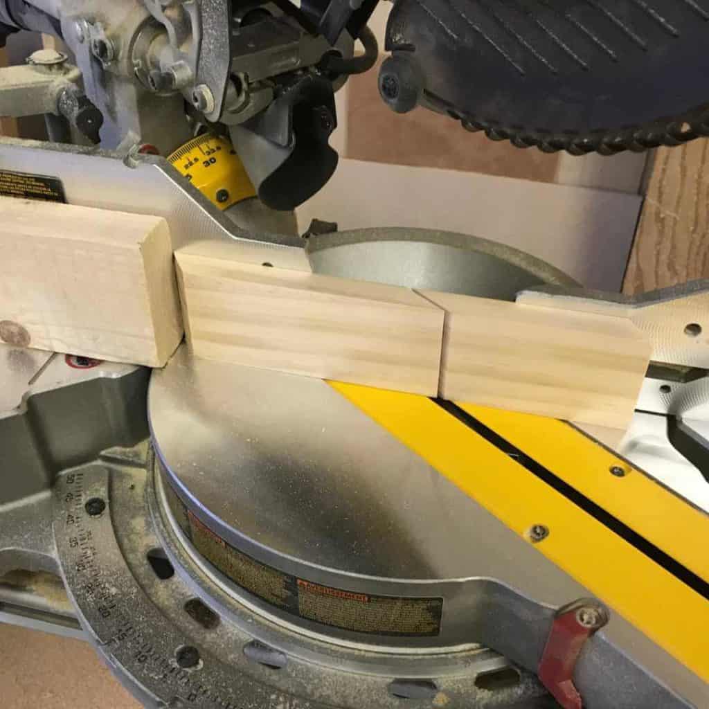 Stop block placed on miter saw to cut a 54 degree angle on 1 x 3.