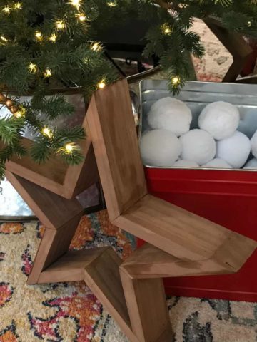 DIY Wooden Star under a Christmas tree as Christmas decor.