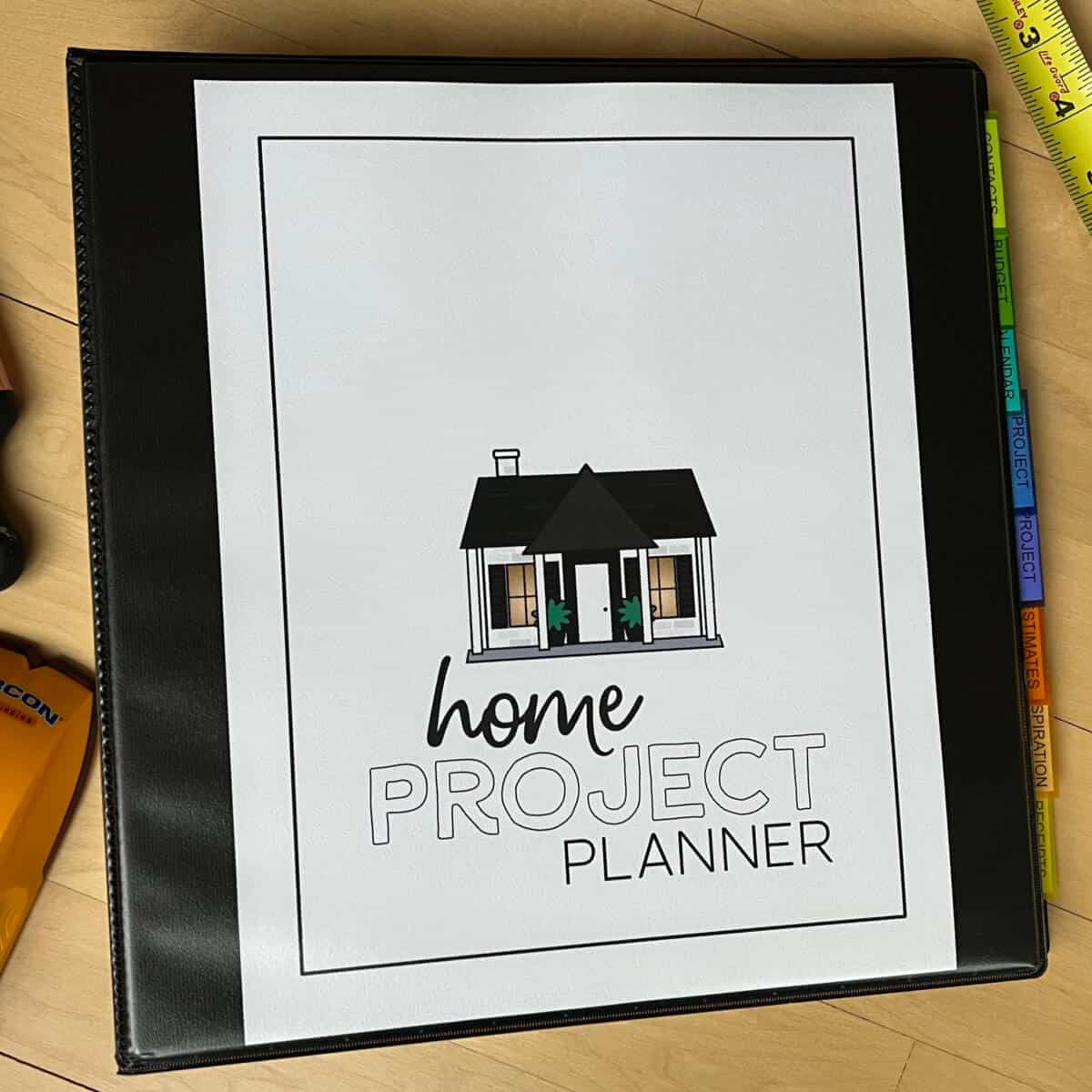 Home Project Planner with a paint brush, stud finder, and tape measure nearby.