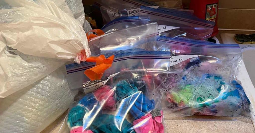 Tie dyed shirts soaking in Ziploc bags.