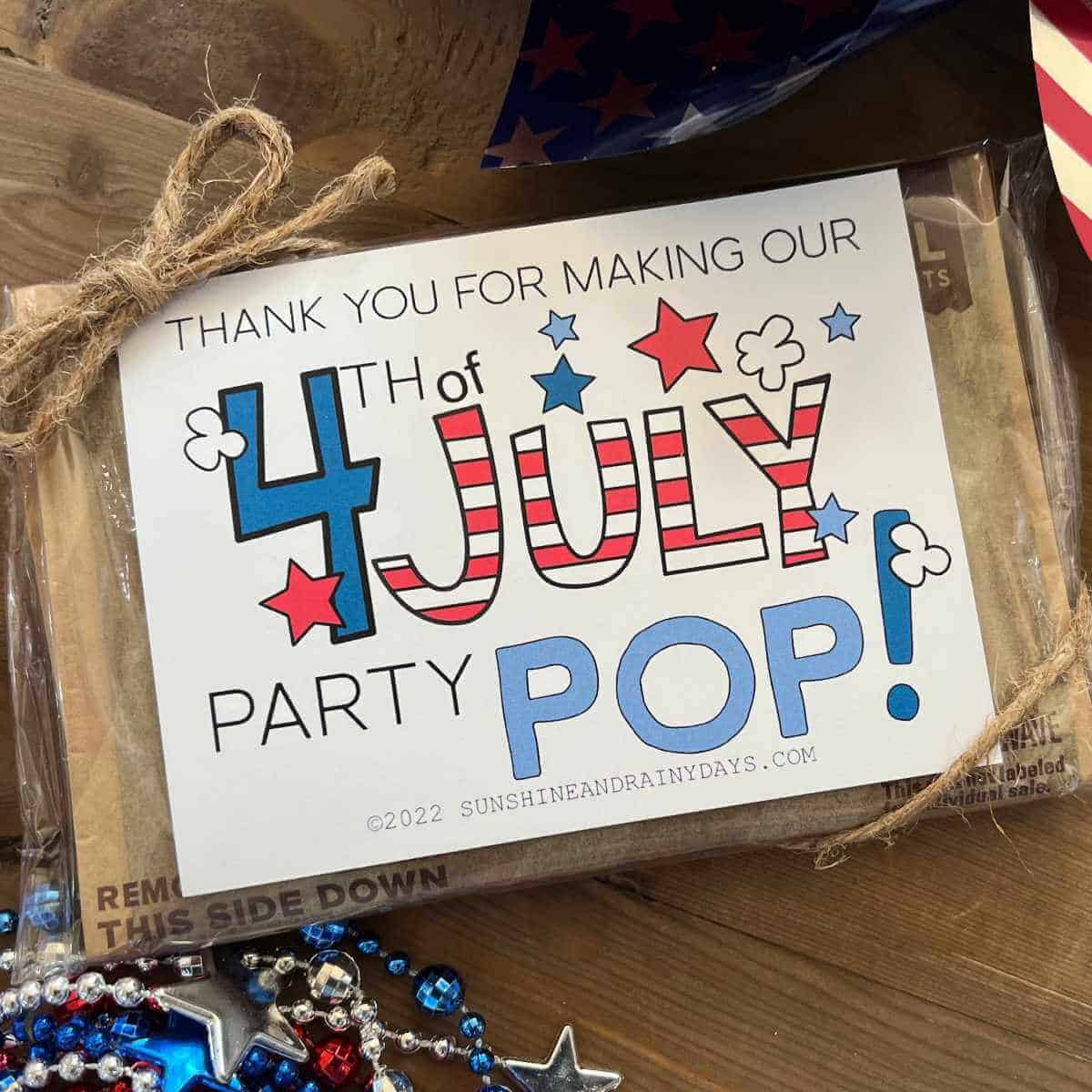 4th of July microwave popcorn tag on a bag of microwave popcorn with jute tied around it.