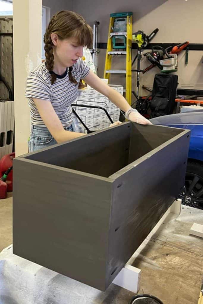 Staining wood boxes to use in a DIY Corner Bookshelf.