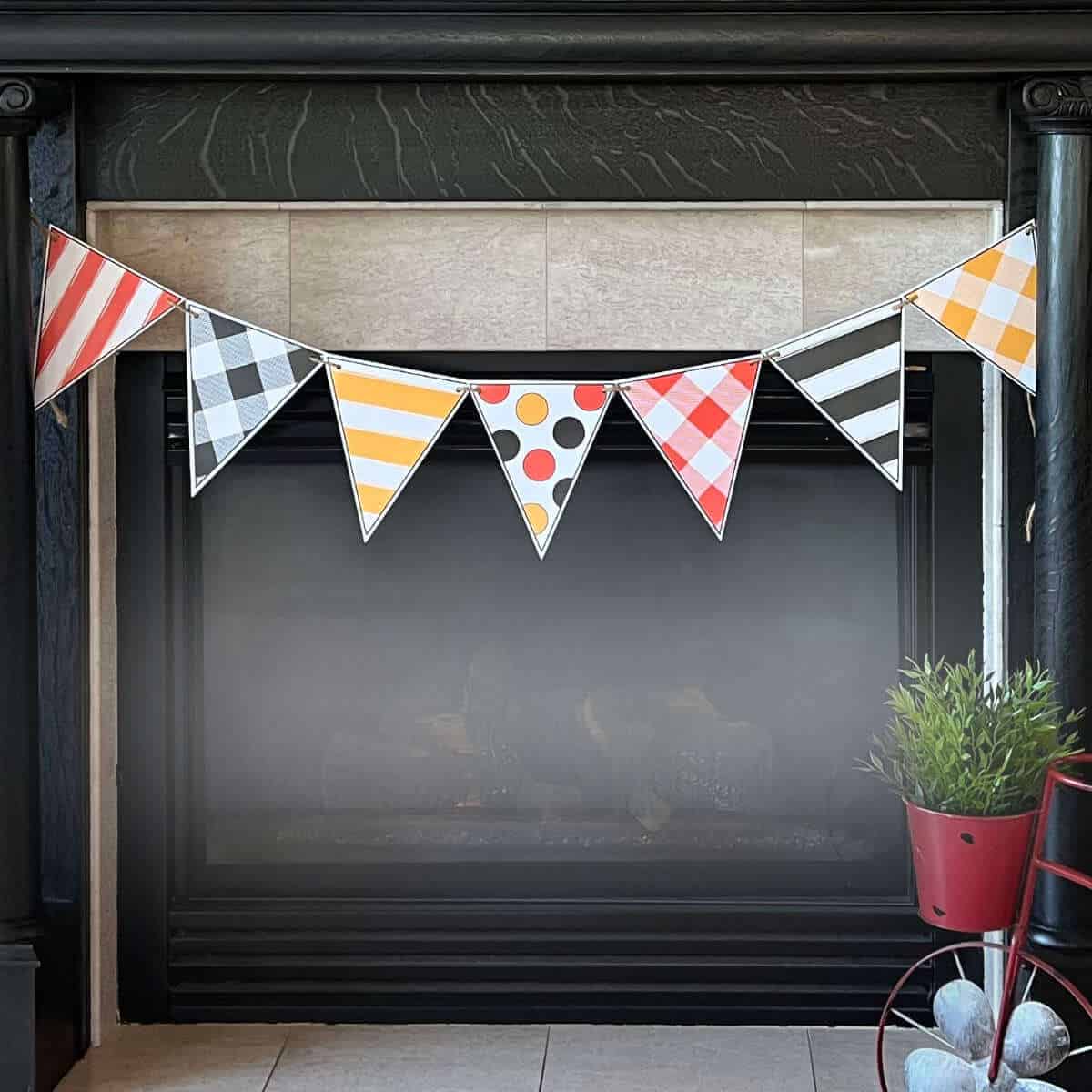 Printable Halloween banner hung on a fireplace mantel.