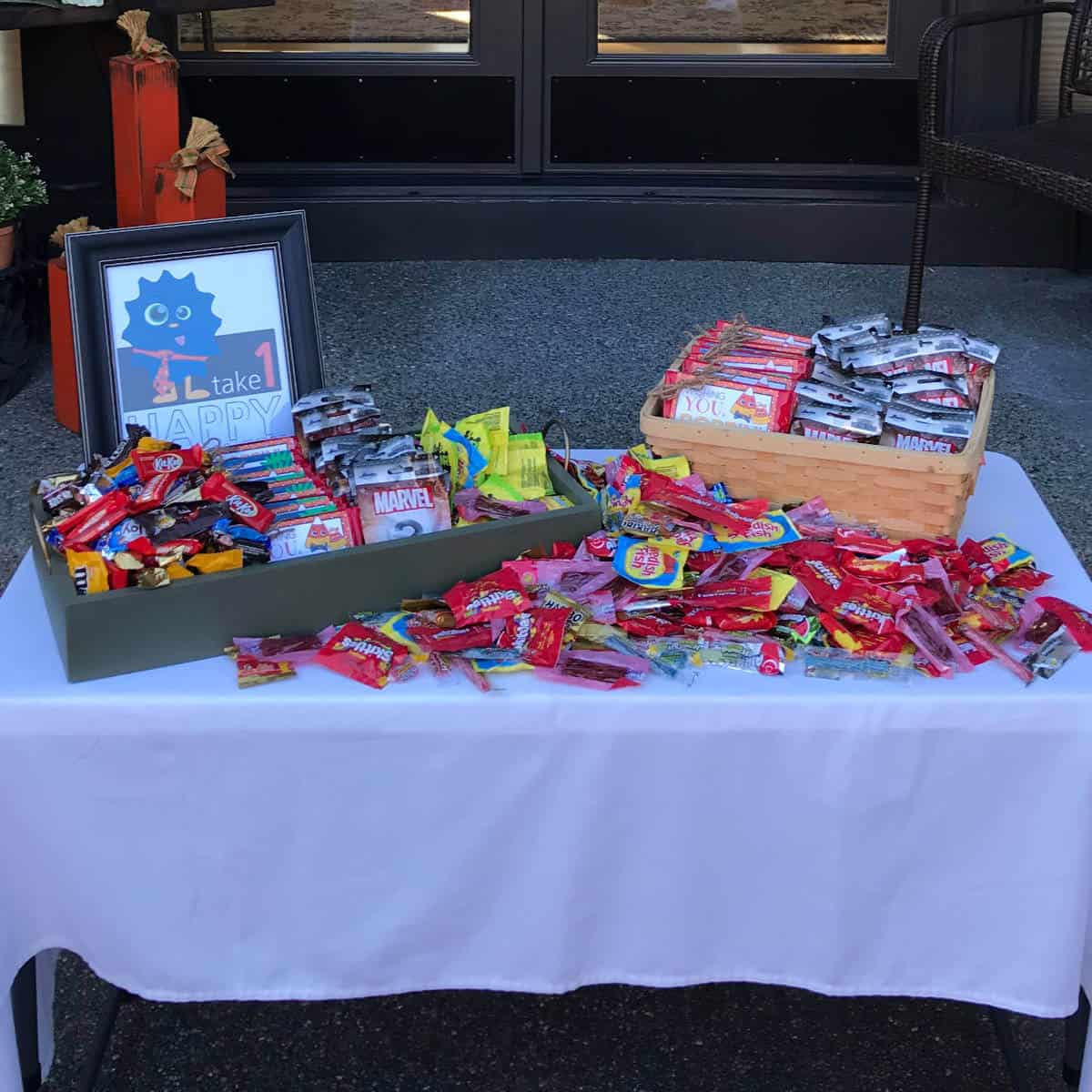 Trick-Or-Treat table set up with candy and snacks and a sign that says Please Take One.