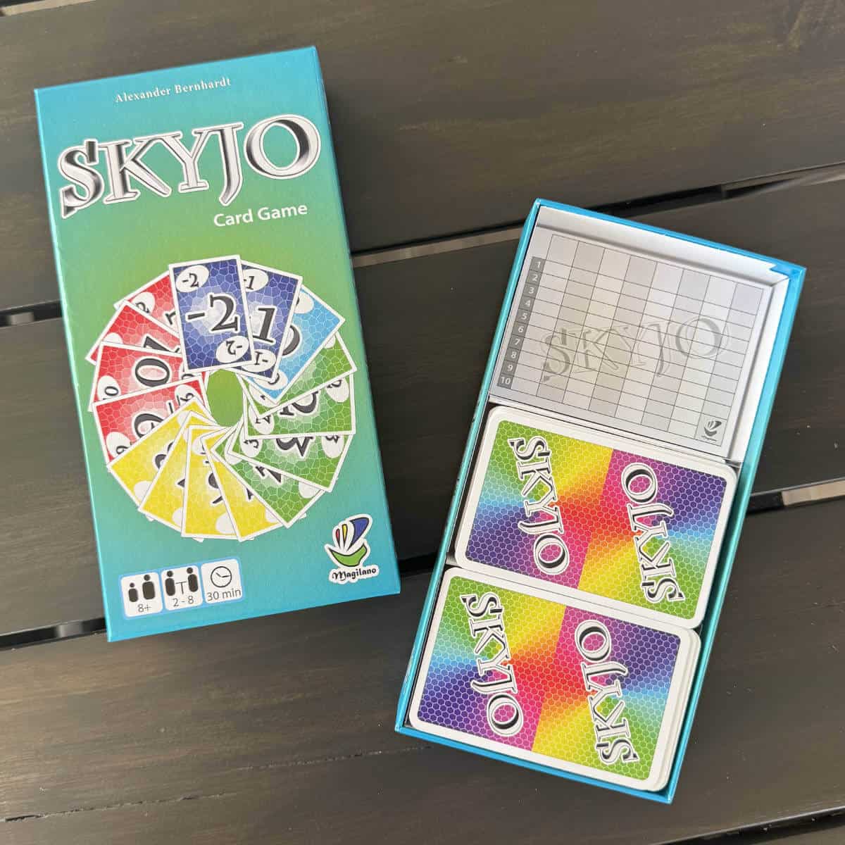 Image of a game called SKYJO with the lid off and sitting next to the box bottom with cards inside.