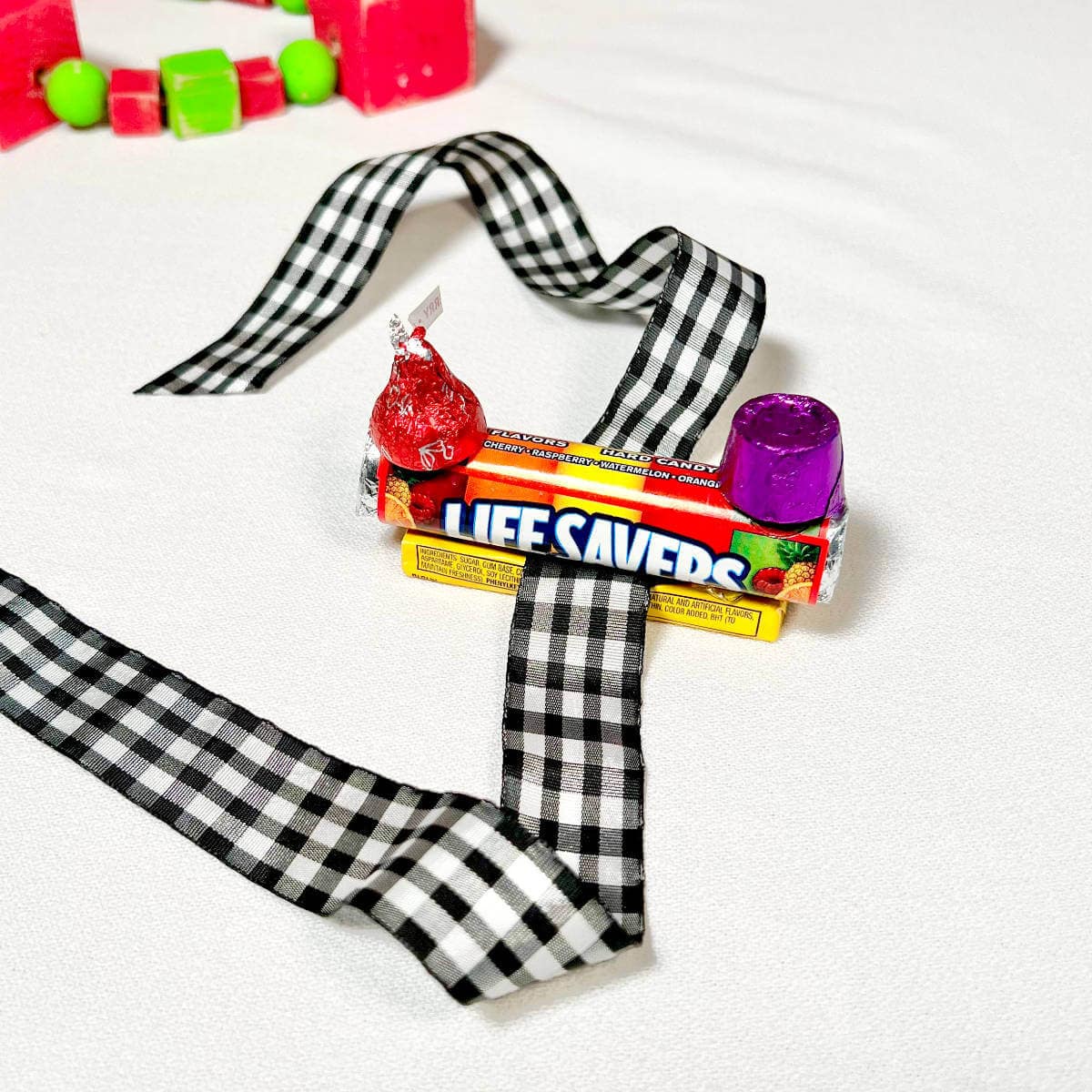 Lifesavers, Juicy Fruit, a Rolo, and a Hershey's Kiss attached together to form a candy train.