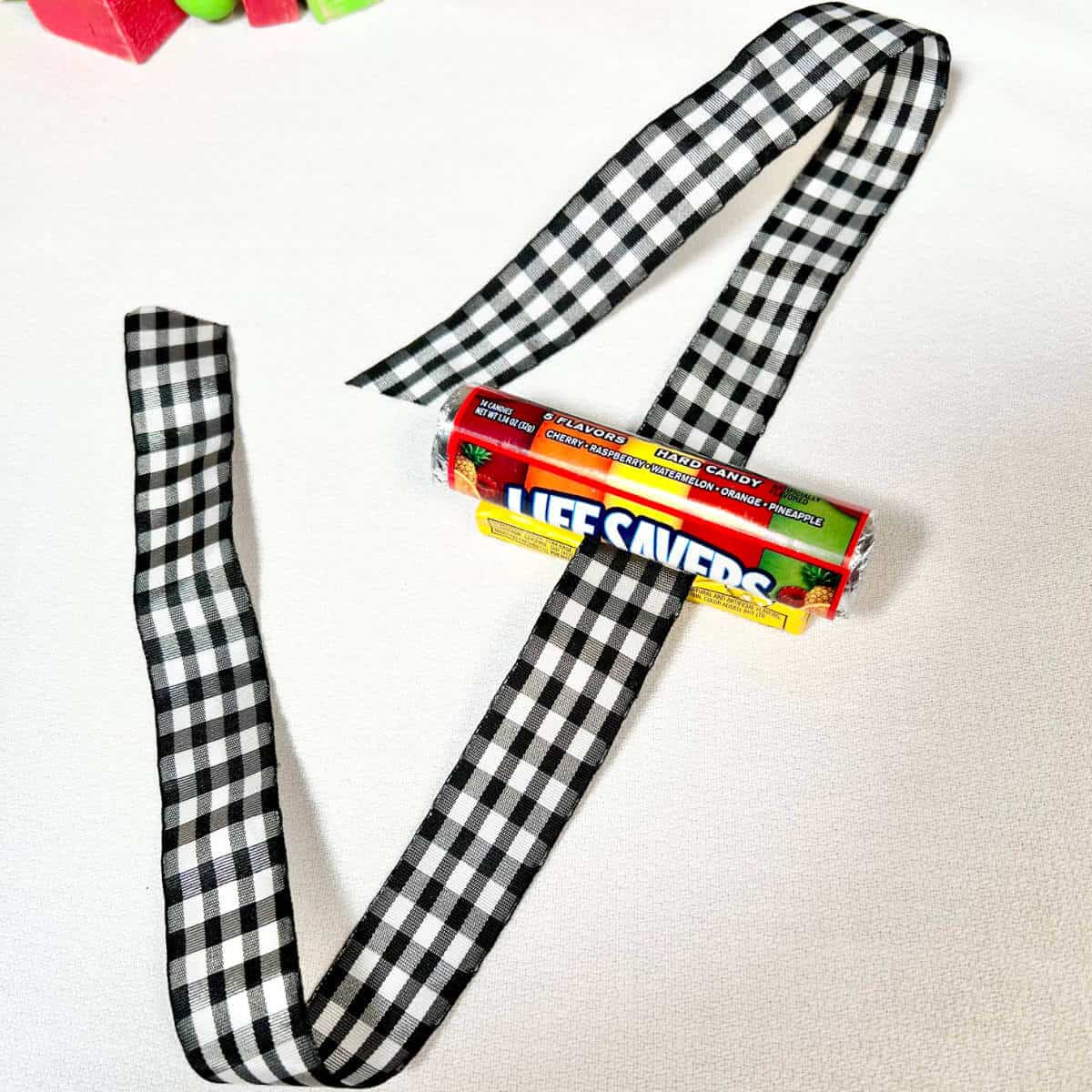 Lifesavers adhered to a pack of Juicy Fruit gum with a ribbon in between the two.