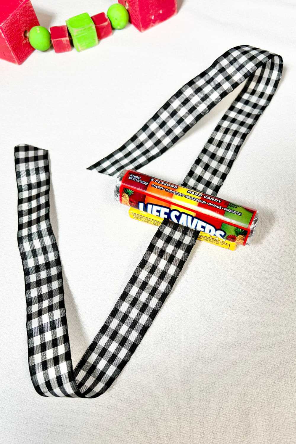 Lifesavers adhered to a pack of gum with a ribbon to make a candy train ornament.