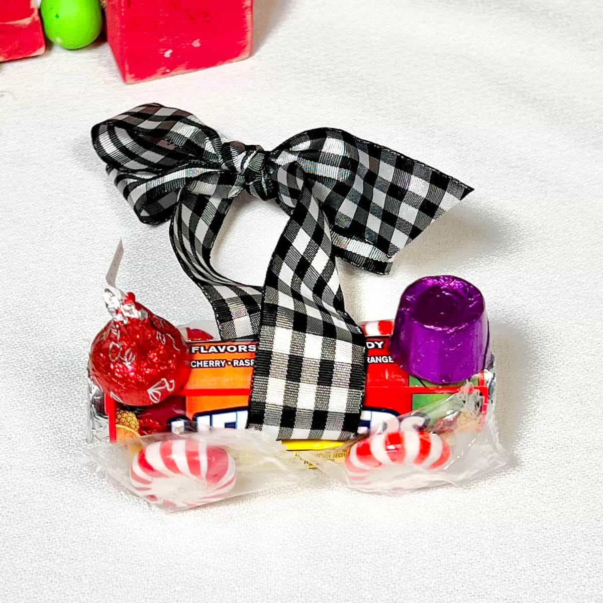 Candy train ornament made out of Juicy Fruit gum, Lifesavers, a Rolo, a Hershey's Kiss, and a one inch wide ribbon for hanging on a Christmas tree.