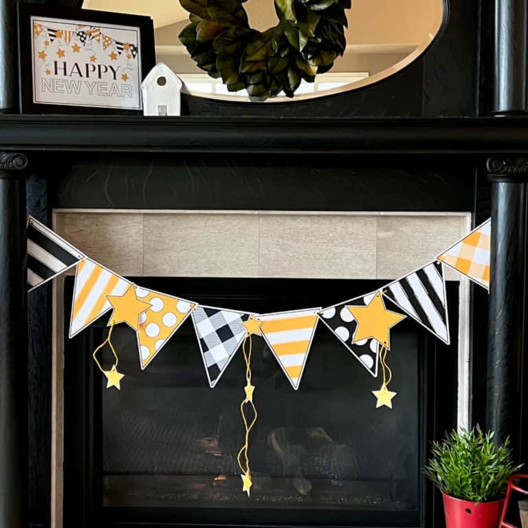 DIY black and yellow banner hanging on a mantel.