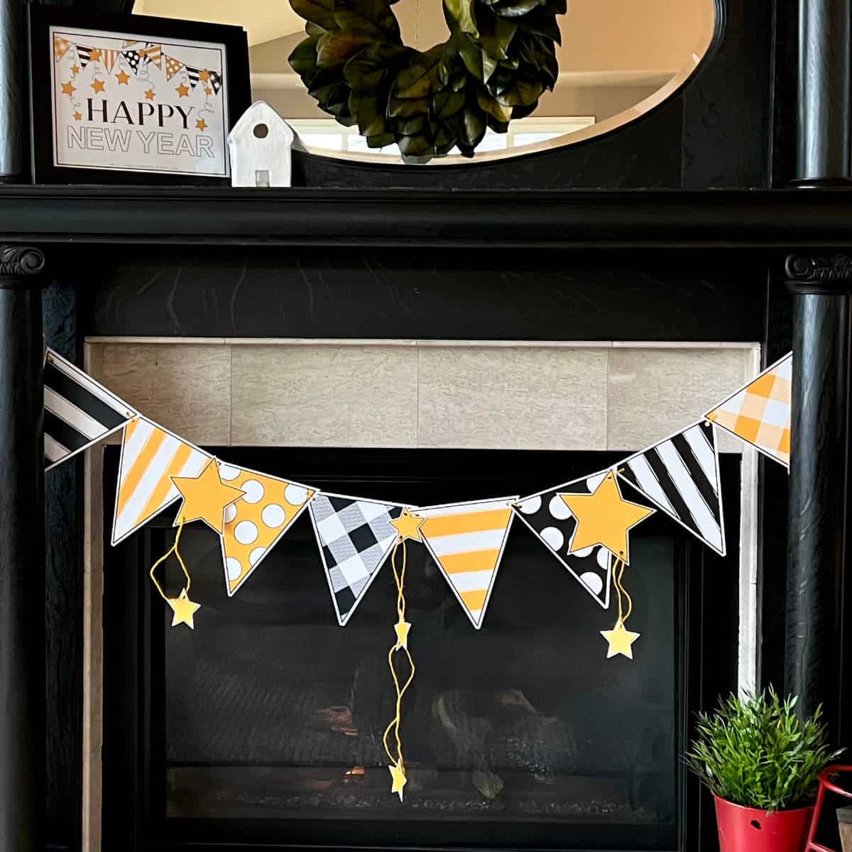 DIY black and yellow banner hanging on a mantel.